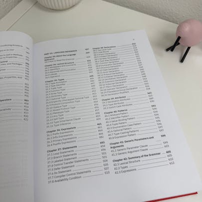 Photo of The Swift Programming Language as a physical print textbook. The book is displayed open showcasing the table of contents.