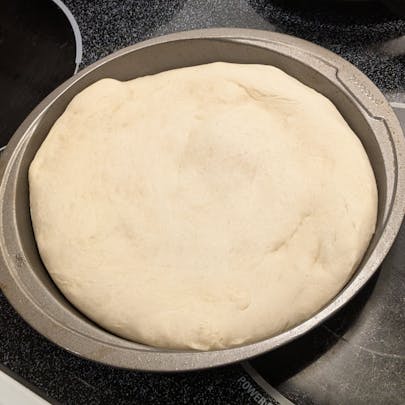 This is the pizza dough. I baked for 5 minutes and then I took the pizza dough out of the oven, and then applied the egg curry leftovers.