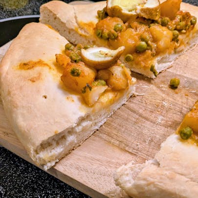 A close-up view of this pizza I made with egg curry leftovers. The close-up is of the crust.