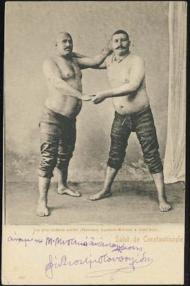 Ottoman Era postcard of Adali Halil and Kurtdereli Mehmet, Turkish oil wrestlers and Terrible Turks