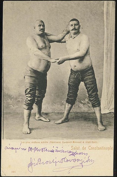 Ottoman Era postcard of Adali Halil and Kurtdereli Mehmet, Turkish oil wrestlers and Terrible Turks