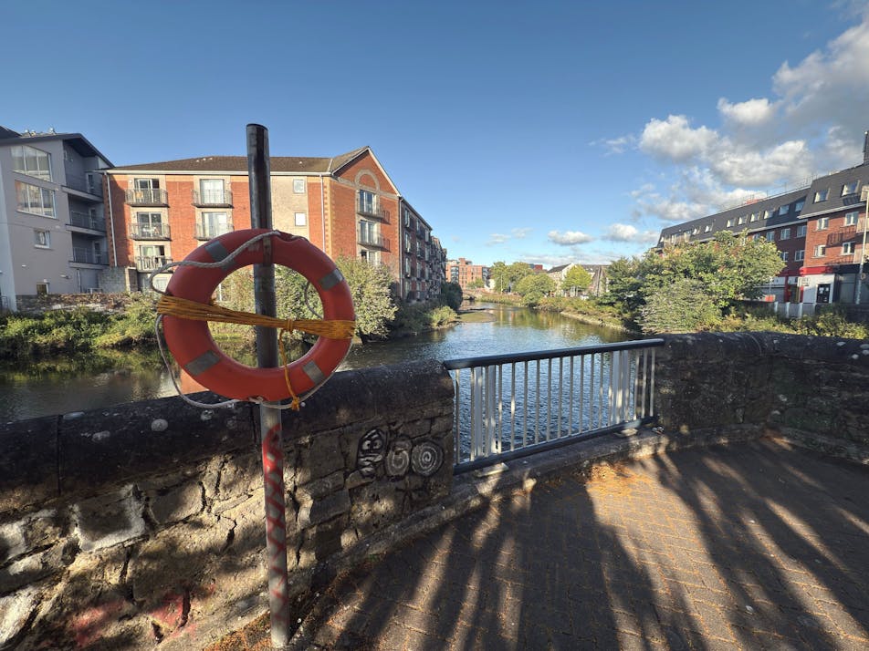 River Lee in Cork, Ireland. Brick houses and trees.