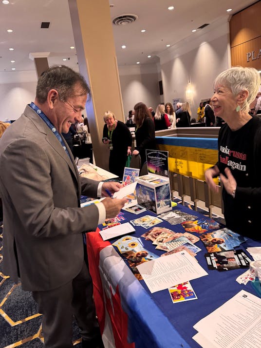 MP Anderson at the XXVIII Triennial Congress of Ukrainian Canadians, russian Embassy Protestors' table.