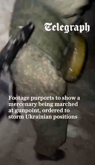 A person in military gear stands against a brick wall, with text discussing accusations against Russia regarding forced recruits.