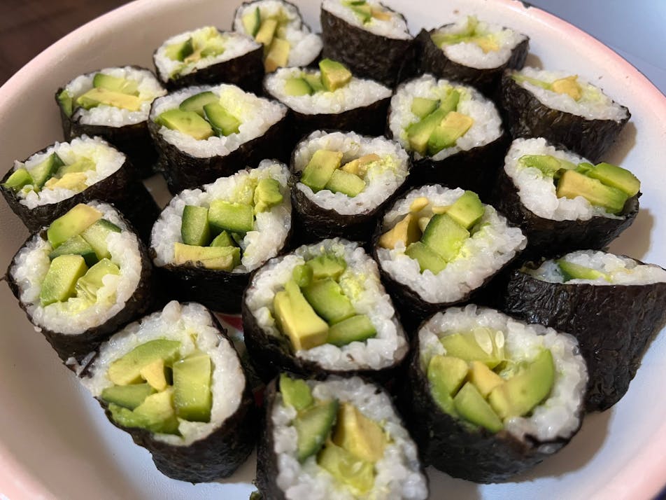Cucumber and Avocado sushi handroll sliced into bite-sized pieces.